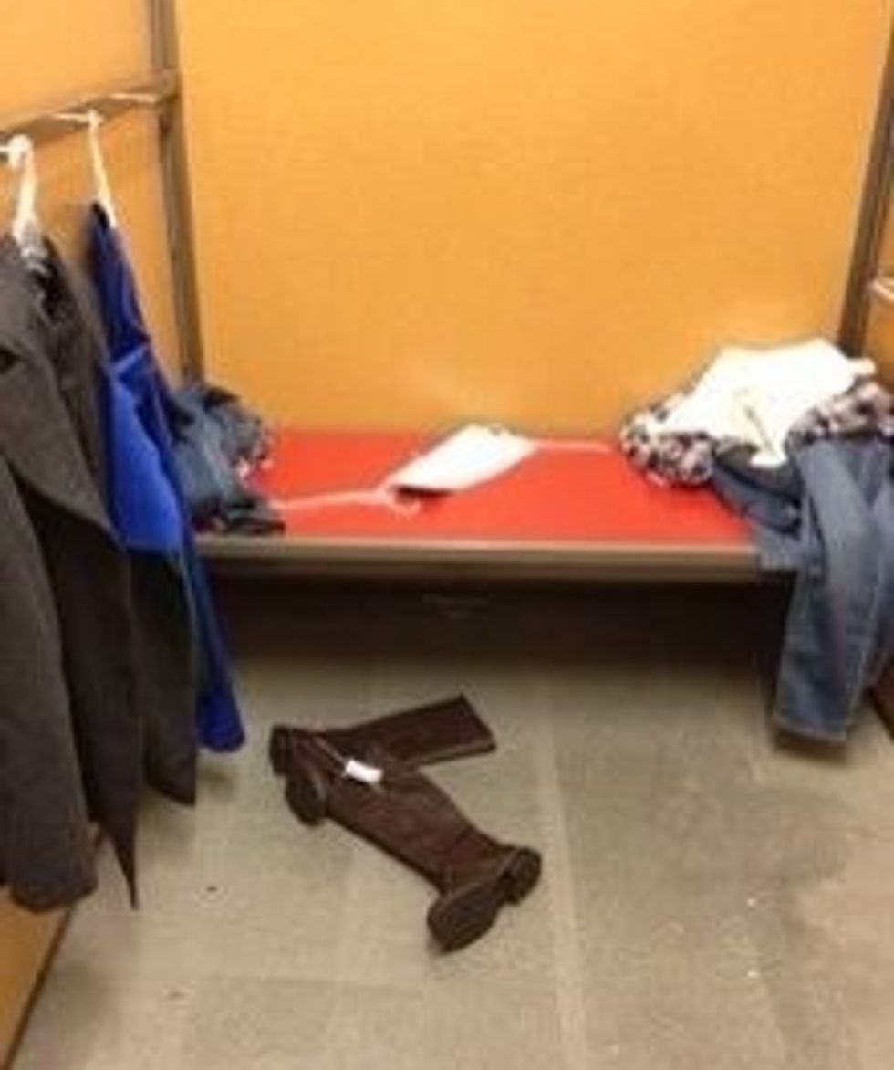 Step inside a messy fitting room at a clothing store. Fold and organize everything for the sales associate.