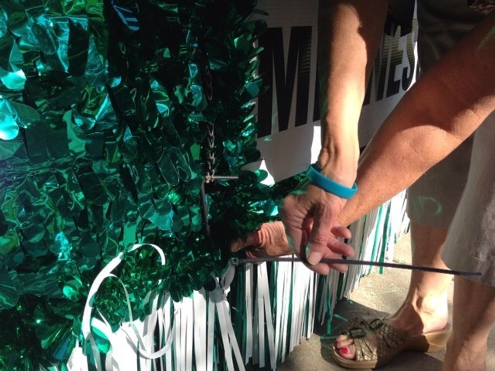 Step off the float and pull out the pegs (or twist ties) at the four fold-up corners.