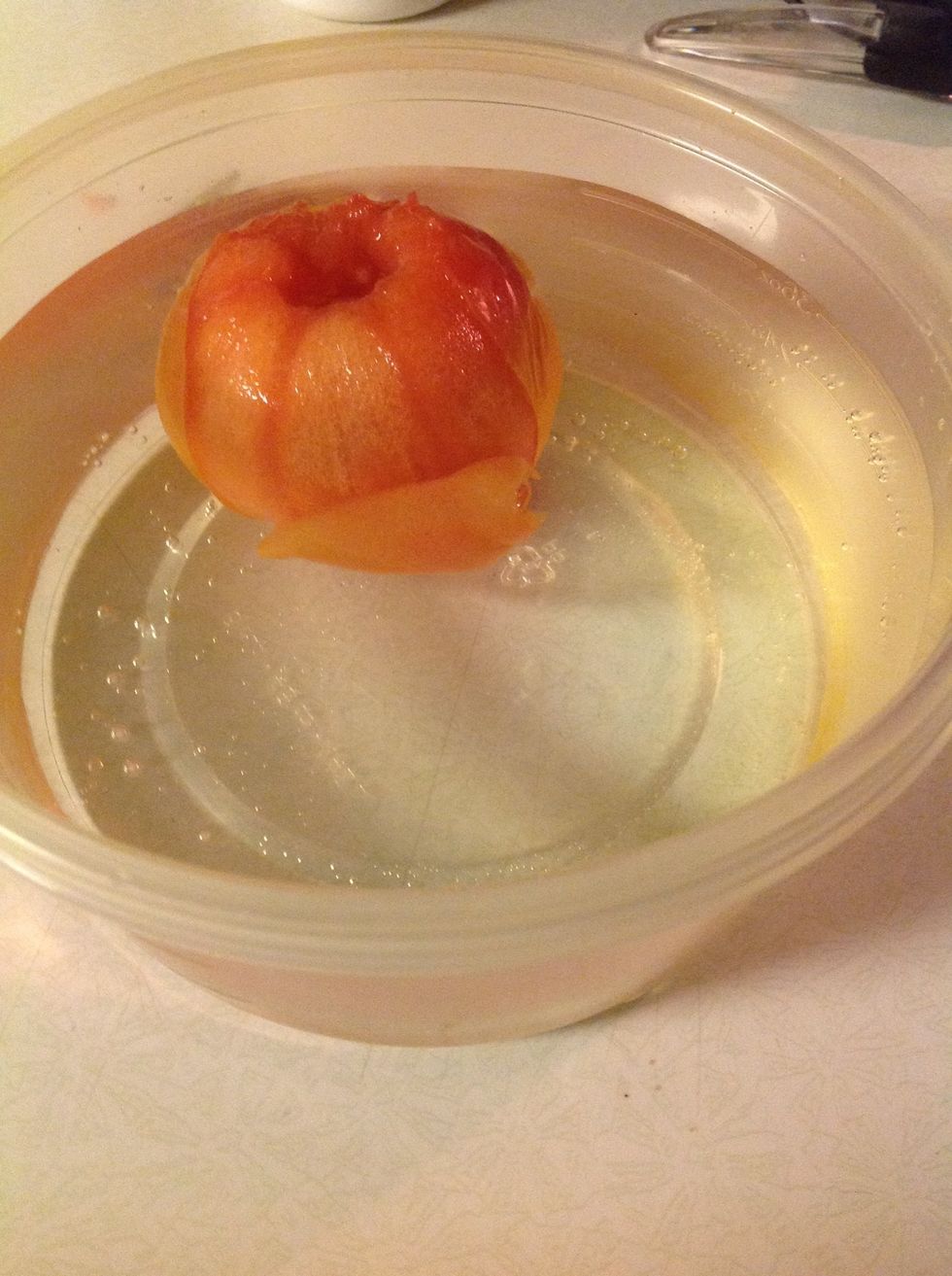 Step Six Place the tomato in the ice water.Let it completely cool. The skin should peel right off easily and some might end up in water.Pull out of the water and start at the X and pull down the skin.