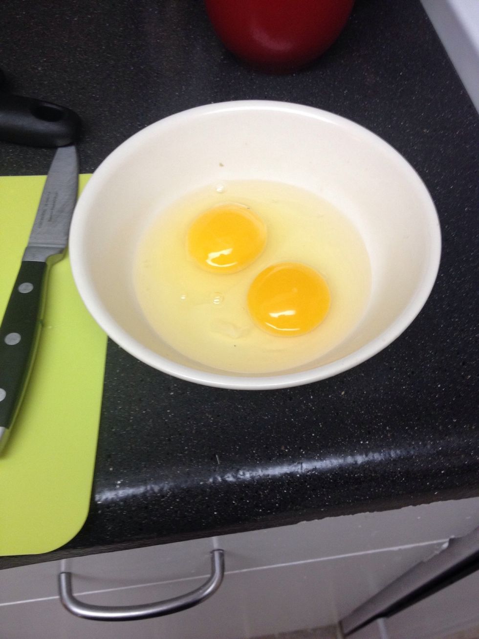 Step three: crack some eggs into a bowl and whisk them with a fork
