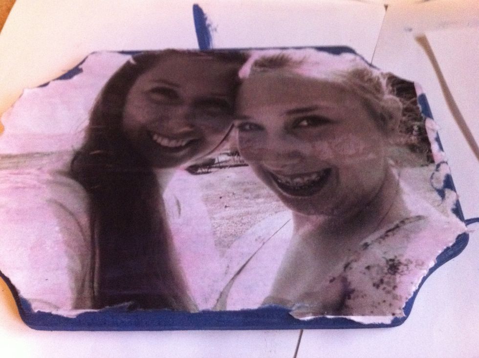 Step Three: Press down the picture on plaque and apply another layer of Mod Podge over picture, making sure to smooth out air bubbles. You will notice it turns the printer ink a slight pink color.