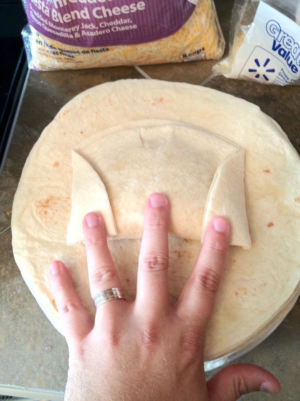 Step two: fold the sides in. (if you overfilled the burrito, they will bust out on the sides at this step.)