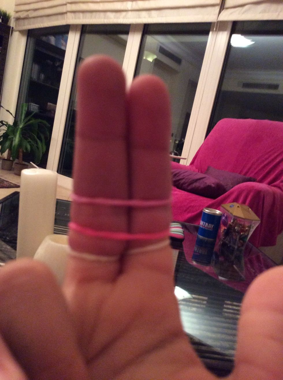 Step two, second take two other rubber bands and put them normally on top of the other rubber band.
