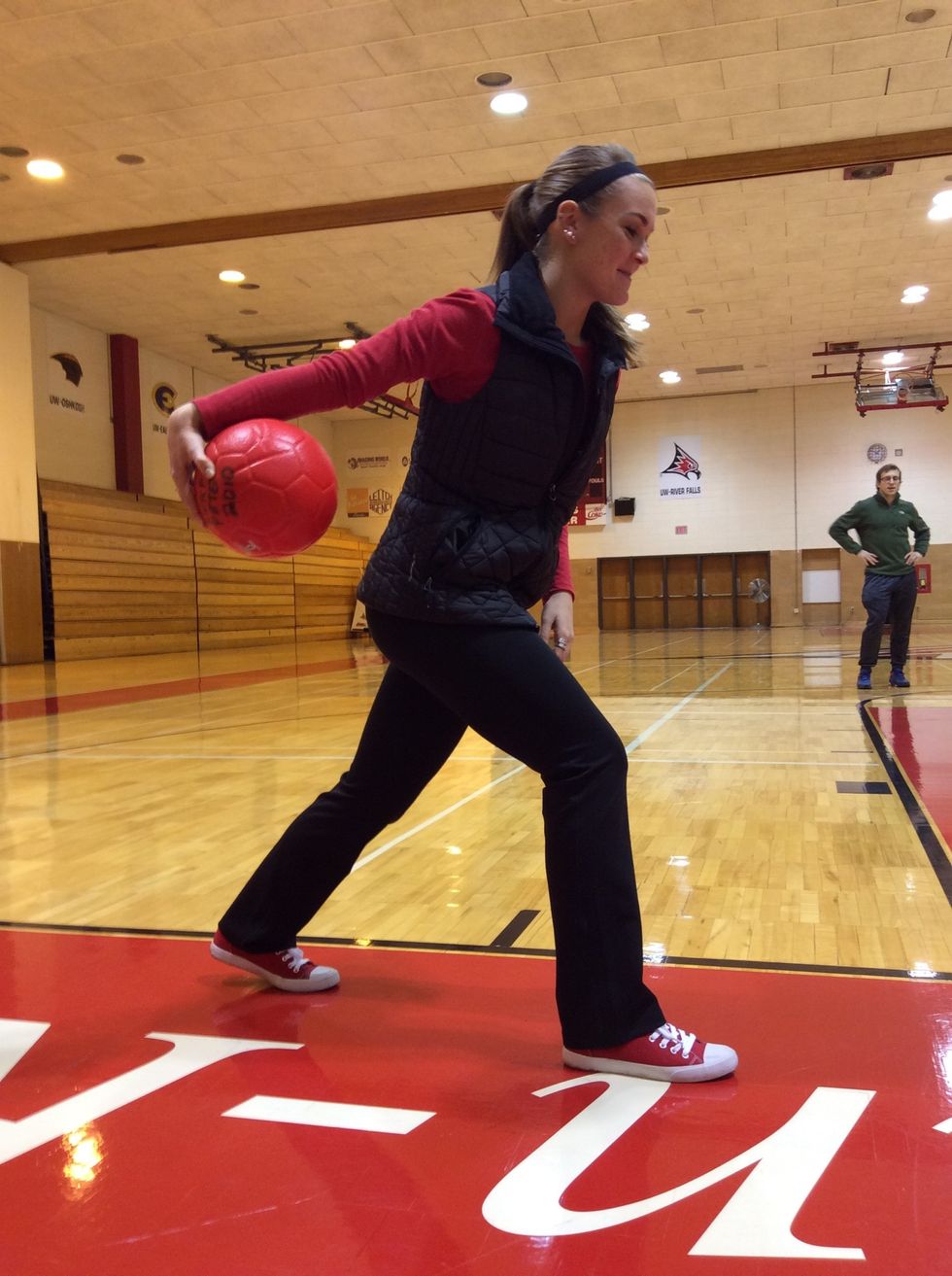 Step with dominant foot while bringing ball behind body.