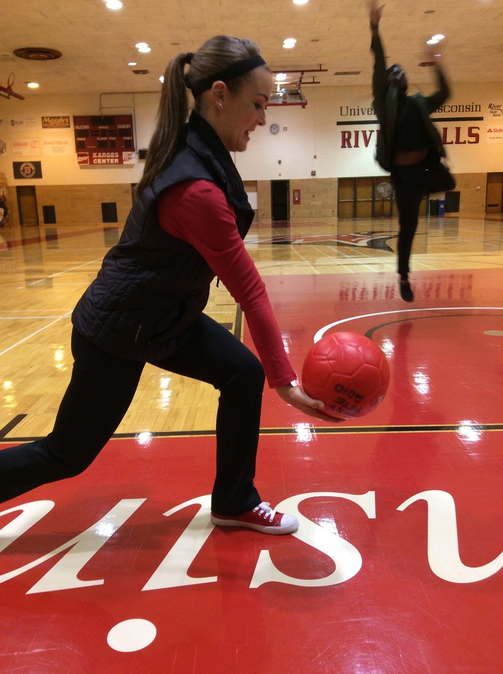 Step with dominant while forcefully bring arm, forward to guide ball onto line with dominant hand