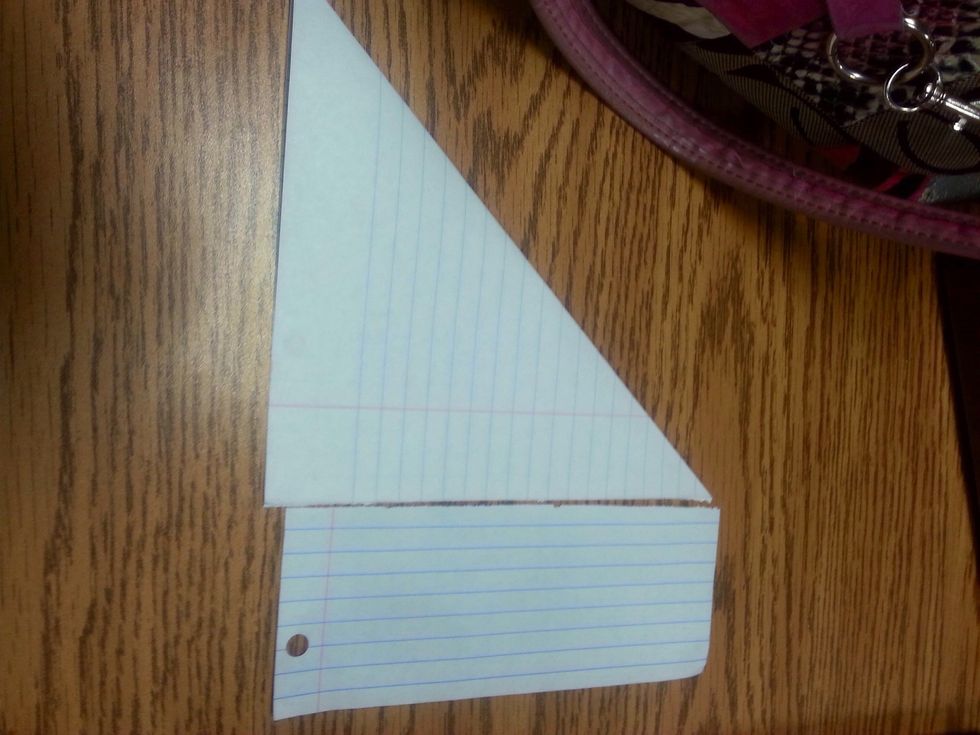 Step3: rip or cut the bottom hanging piece of paper. Now it will look like a triangle.