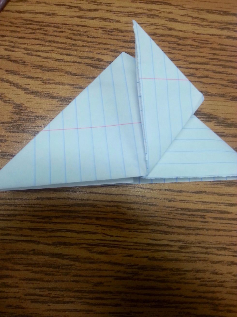 Step6: take the right side of the triangle and fold it all the way to the top, do it to the front and back