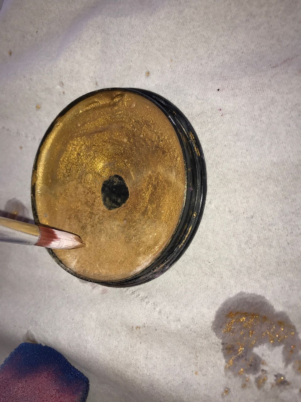 Step9/then get the tip of your paint brush and dip it into another colour