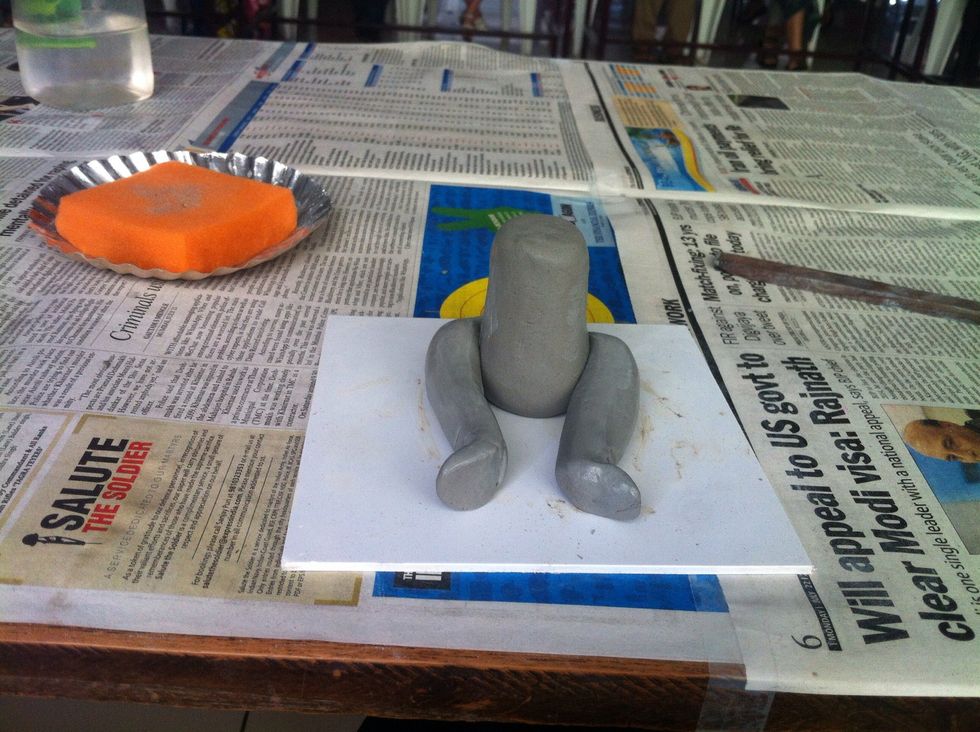 Stick 2 long shapes to make legs Stick with the help of water and a bit of extra clay