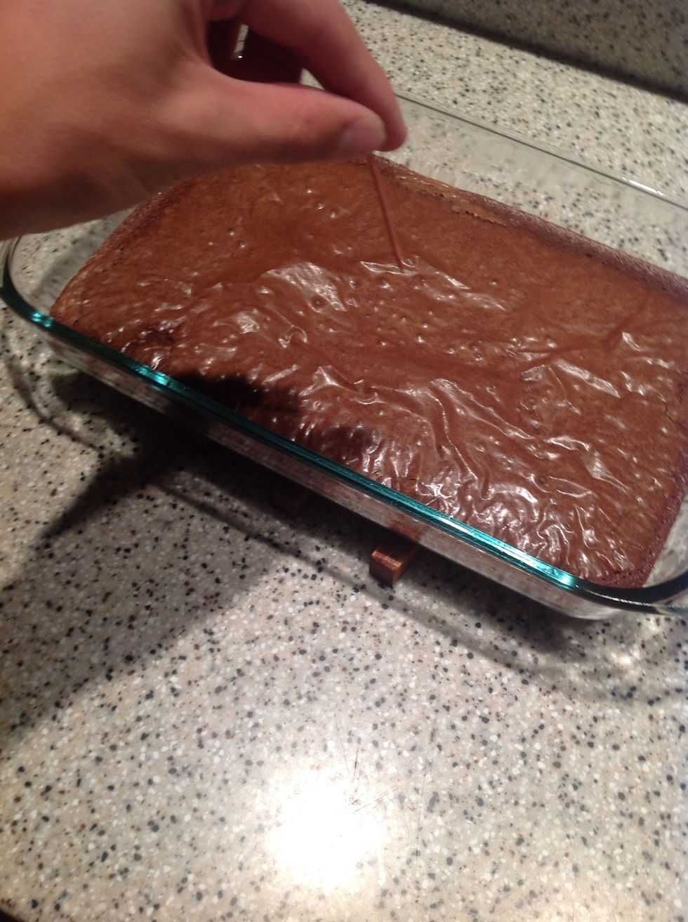 Stick a toothpick in the middle of the pan and take it out. If the toothpick has brownie mix on it, put the pan in for a few more minutes. If the toothpick is clean, the brownies are done!!