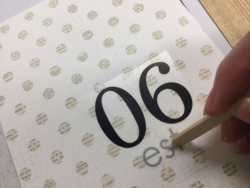 Stick design down in desired location. Use a craft stick or coin to gently rub the shiny side of the transfer film, bonding the design to the surface. Peel away shiny film to reveal adhered design.