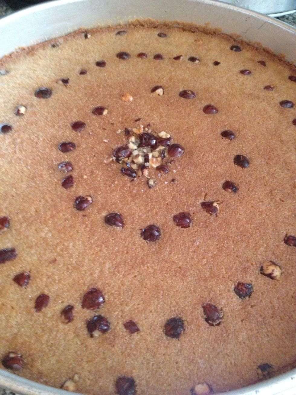 Stick it on the top rack of a 350*F oven for 30 minutes. Afterwards broil the top until it is golden brown.