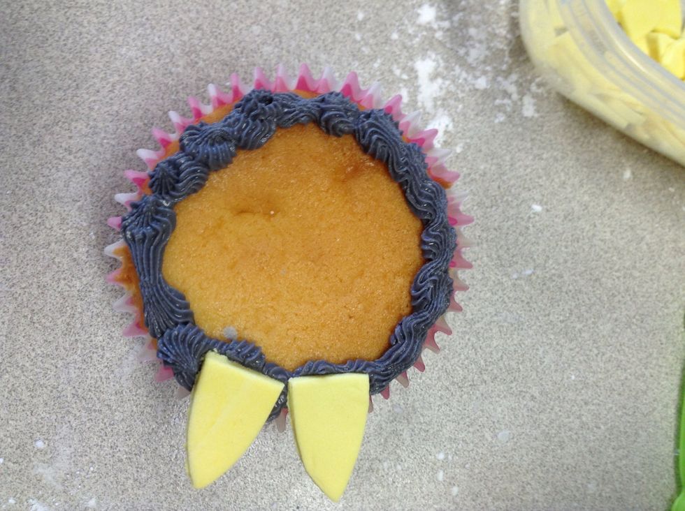 Stick on bigger yellow petals and continue until the circumference is full