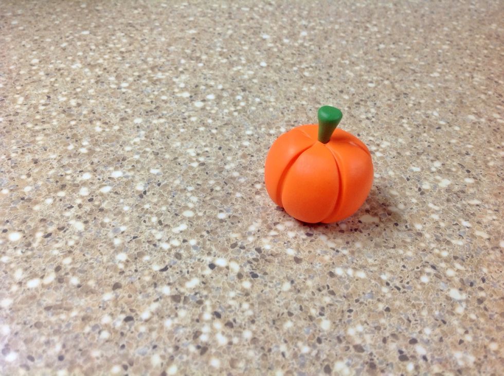 Stick the cone shape, tip down, into the hole in the top of the pumpkin. Do not press down to hard or the stem will become misshapen.