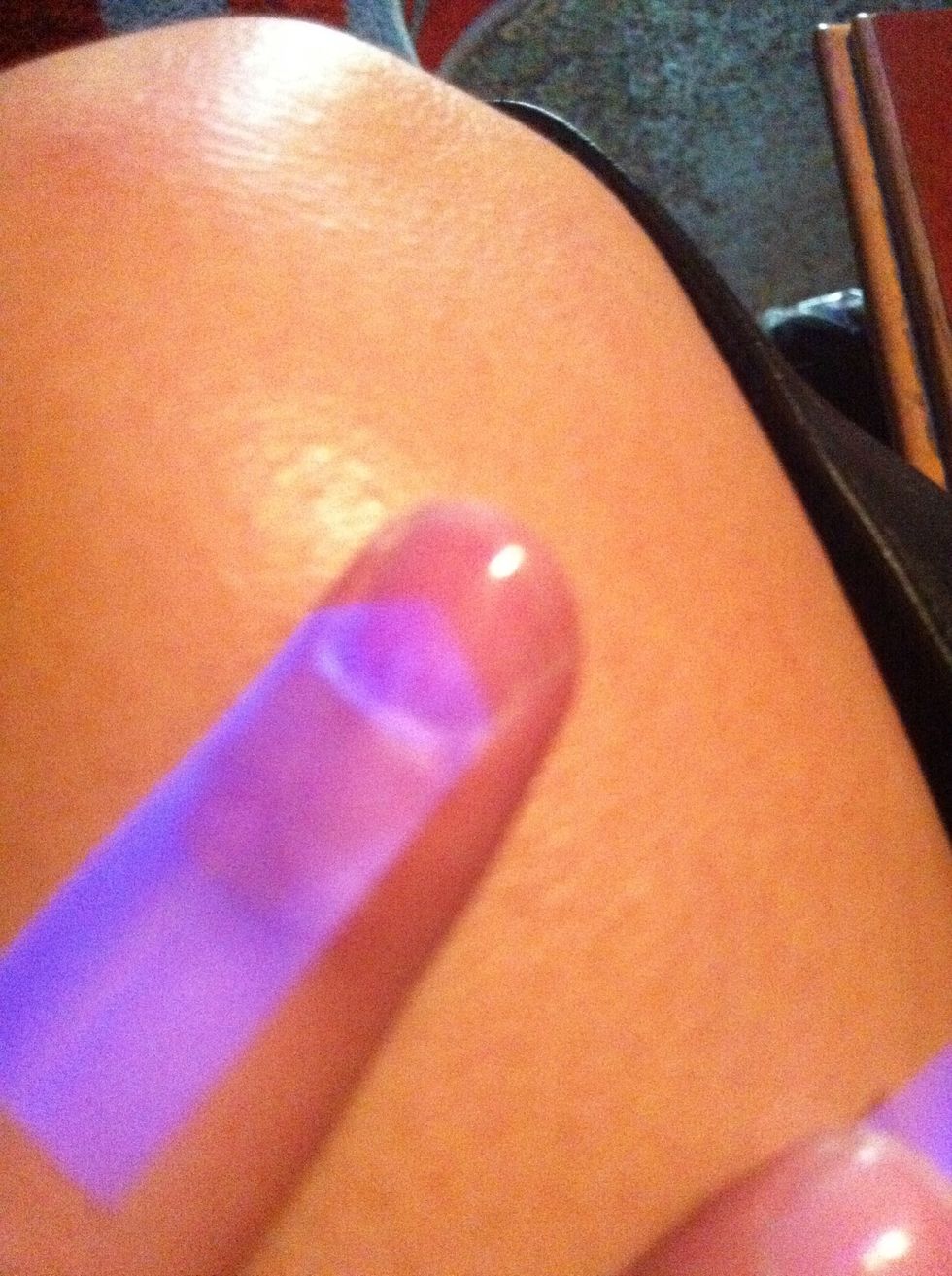 Stick the cut tape to your nail in which ever direction you please, leaving open nail to apply your first color on.