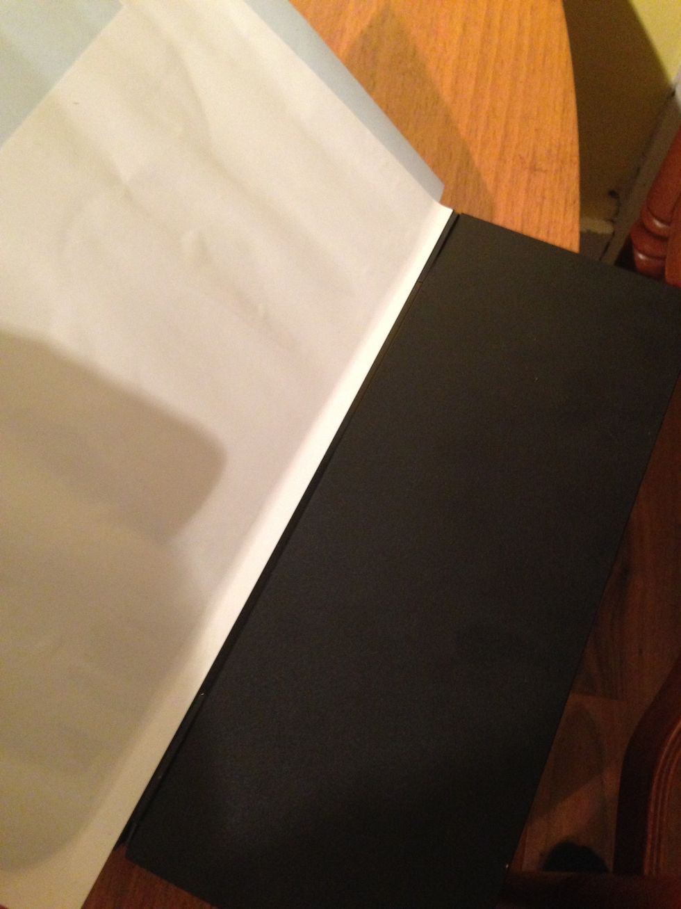 Stick the exposed 2cm of vinyl to the edge of the PS4 then remove the remaining backing paper and smooth over.