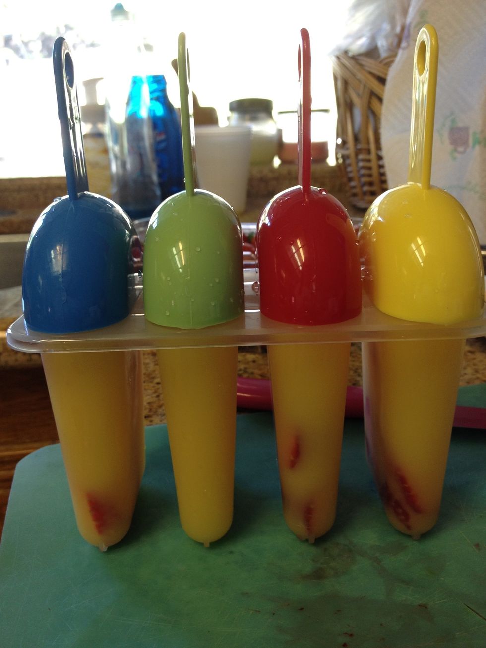 Stick the holders in, try sticking it into a piece of fruit, as this can guarantee a better hold in the popsicle.