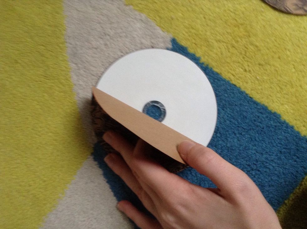 Stick the paper circle onto the disc. Repeat for the second disc.