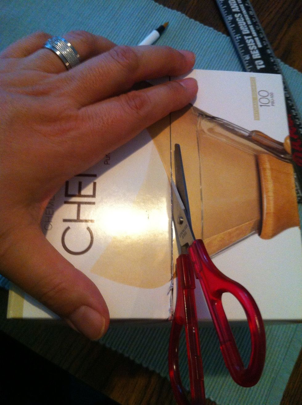 Stick the scissors in the hole you made and cut along your lines. You can use the blade, but I found it easier to keep from cutting the filters inside by using scissors.