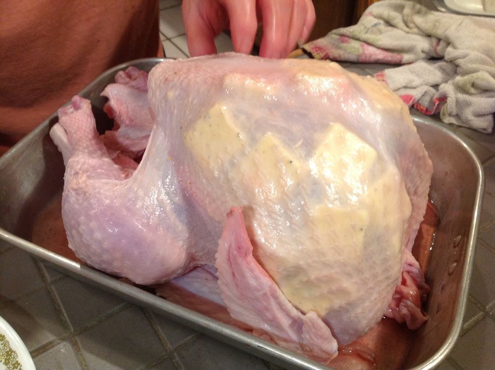 Stick the slats of butter under the skin on both sides of the turkey.