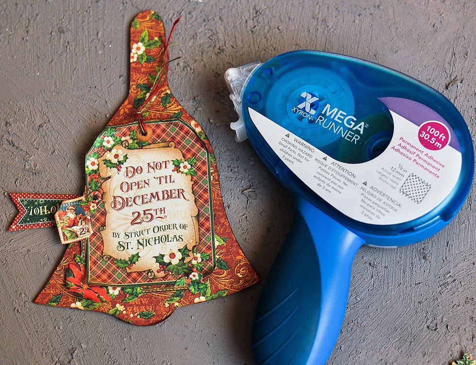 Stick the tag on the thick carton with Mega Runner Xyron