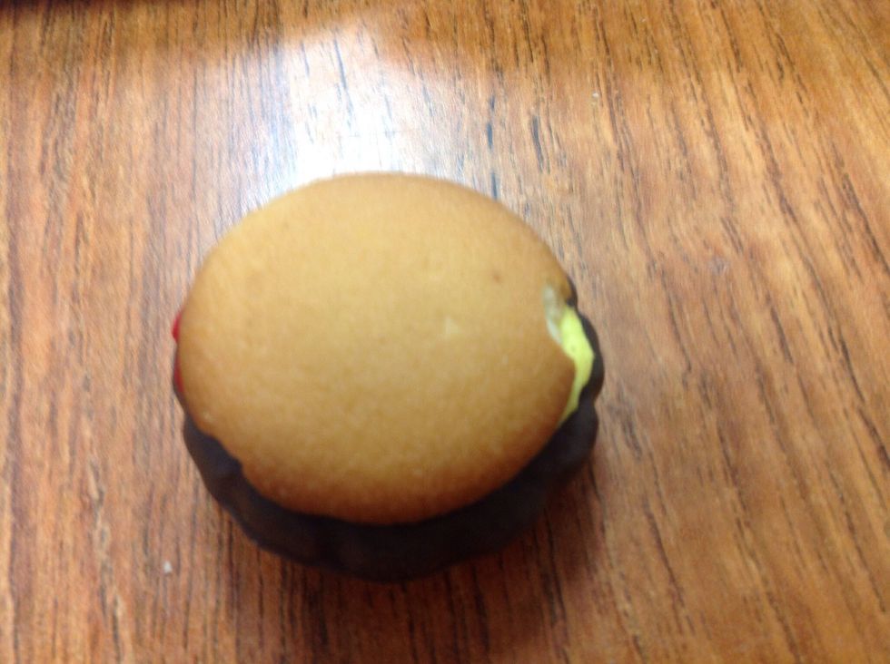 Stick the two vanilla wafers with frosting to the thin mint cookie