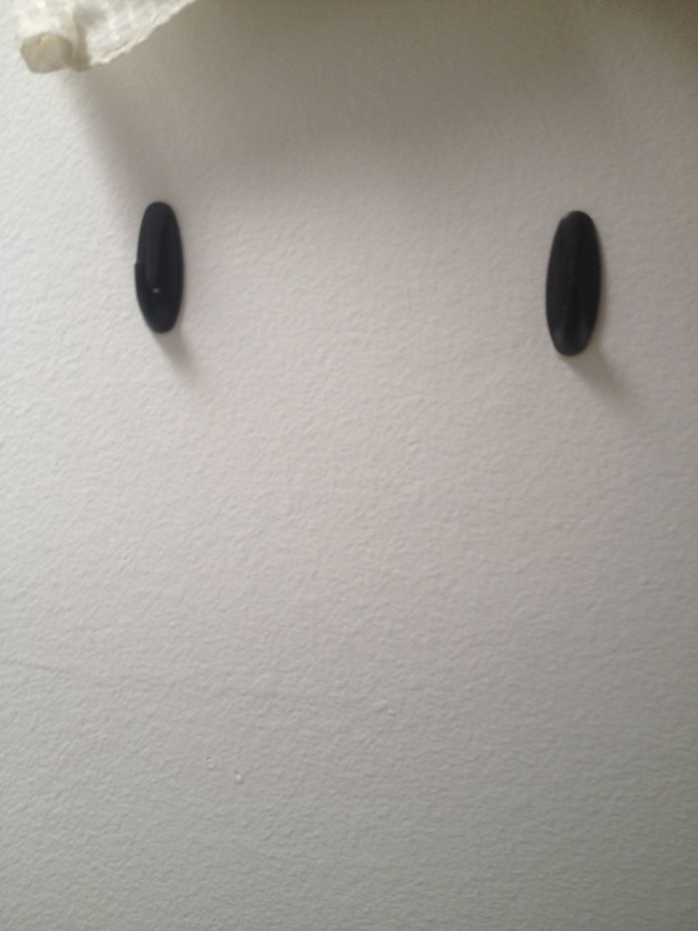 Stick two command hooks at the same level the same length of your rope above the area you want your basket to fall.