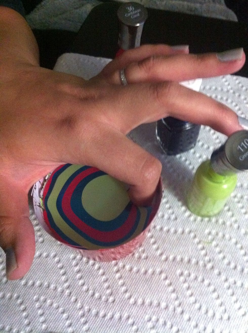Stick your finger where the design is that you made. Leave your finger in the water.