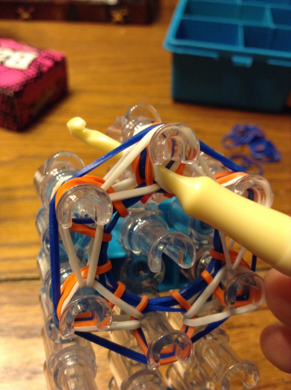 Stick your hook through the top peg and pull another band through.