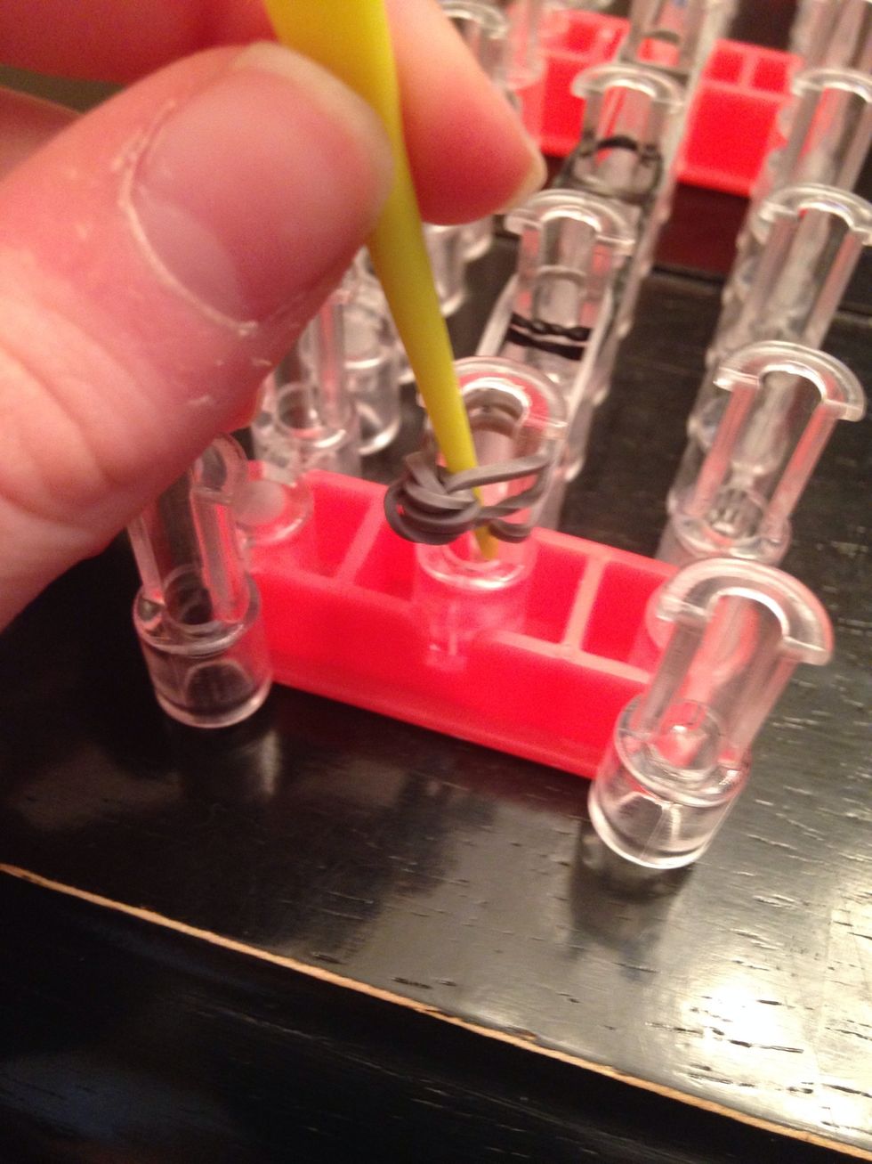 Stick your hook through the whole and grab the bottom two rubber bands