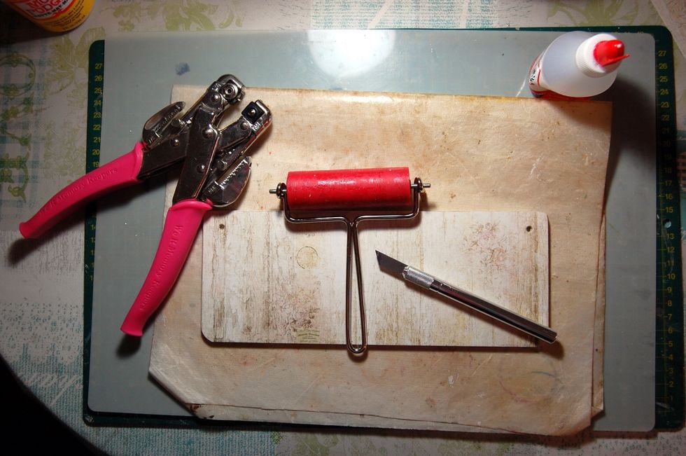 Stick your paper to front of MDF. Make sure stuck down by running brayer over it. Trim round corners, punch through hanging holes. Give back MDF coat of Mod Podge to protect from marks & scratches.