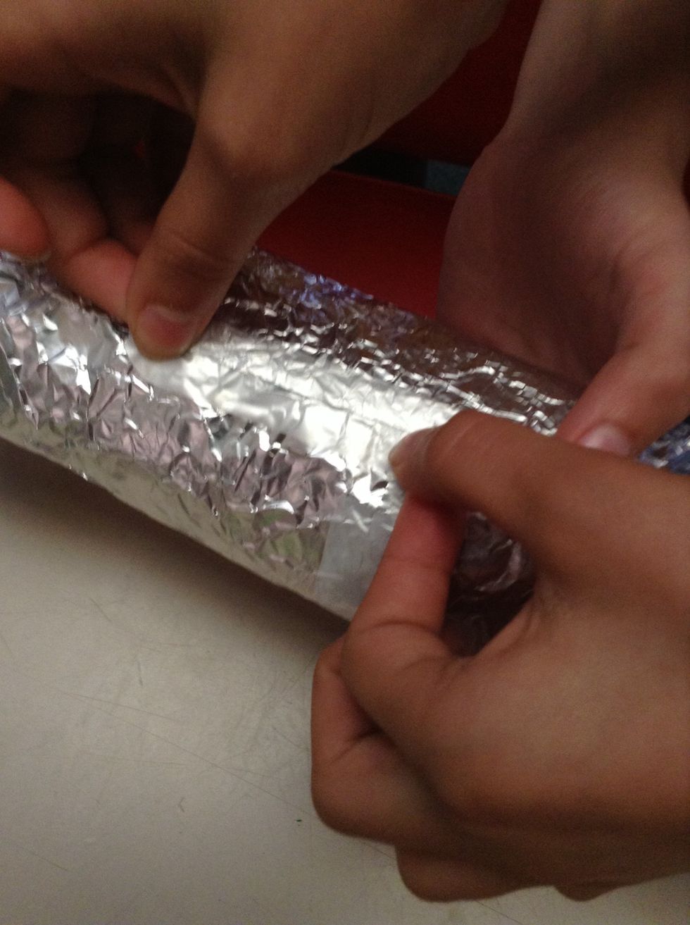 Sticky tape the foil to the bottle.