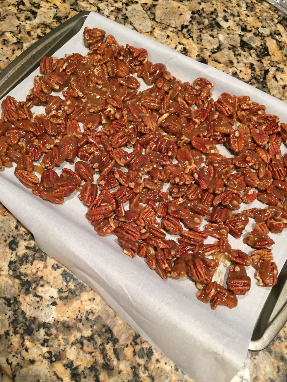 Stir and coat well. Line a sheet pan with parchment paper and spread pecans on pan