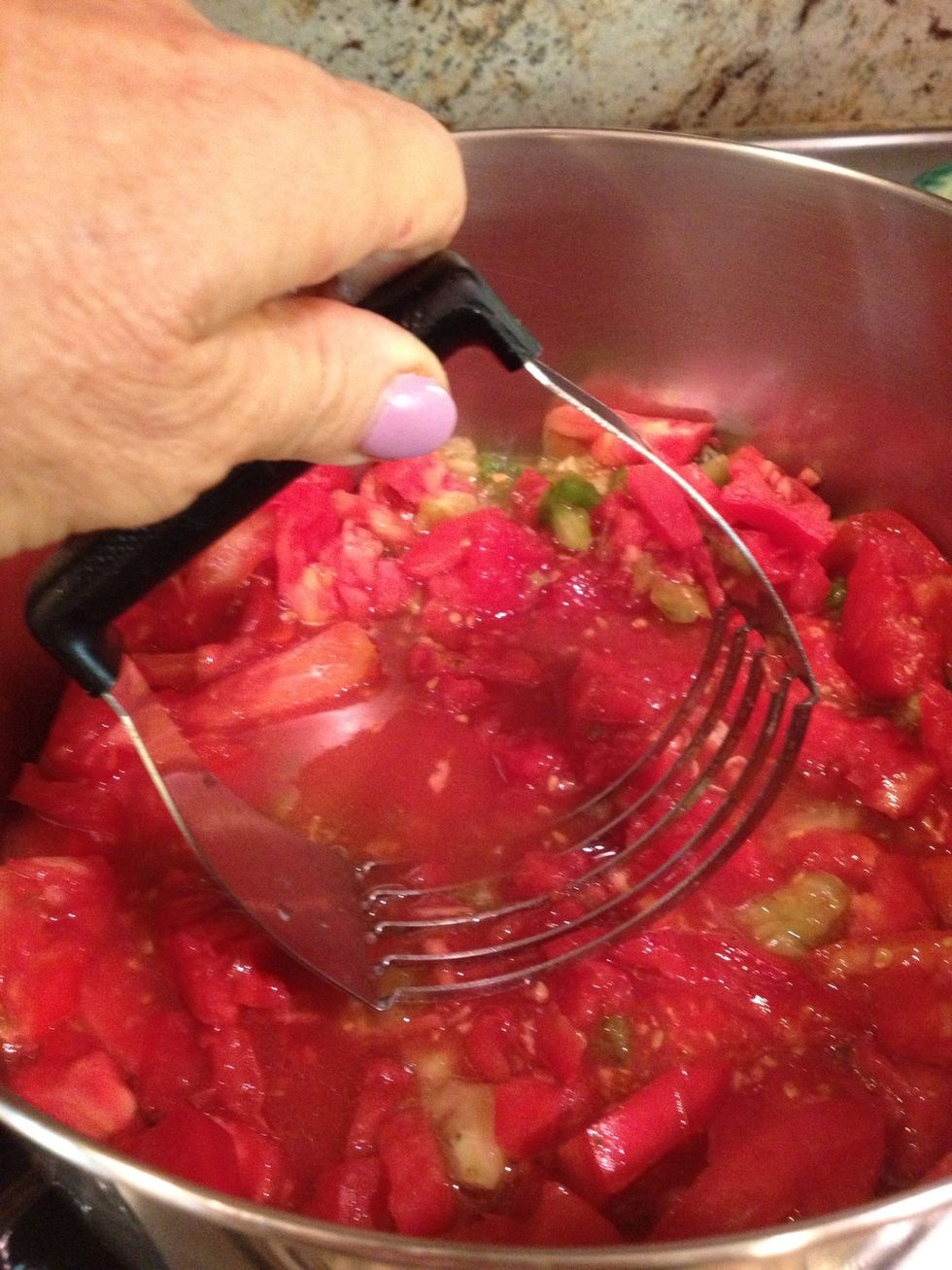 Stir and mash the tomatoes as they cook for 3-5 minutes. I used a pastry blender to break up the tomatoes.