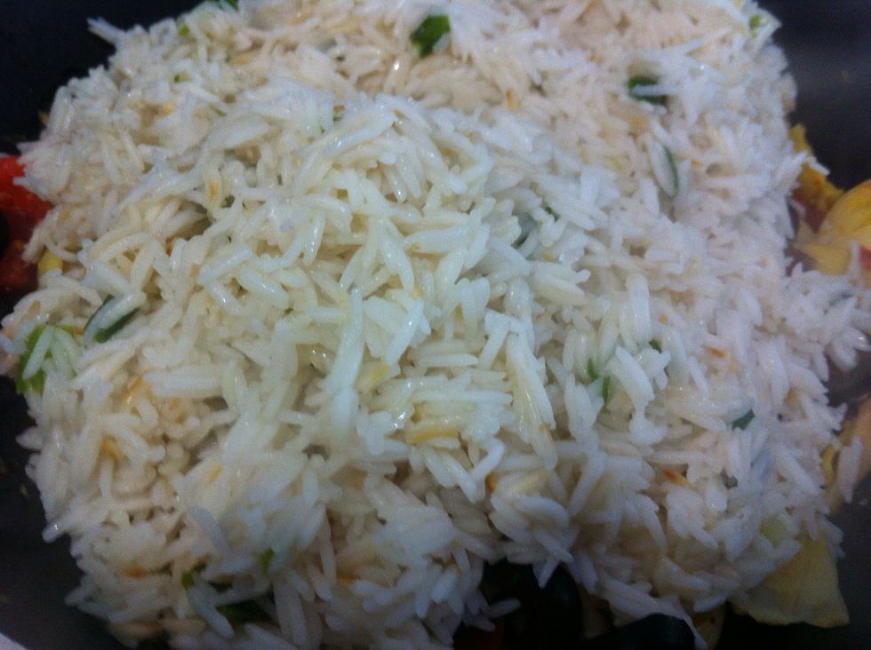 Stir constantly and add water as needed until rice is done, then pour directly over vegetables; continue to stir over low heat to incorporate the flavors