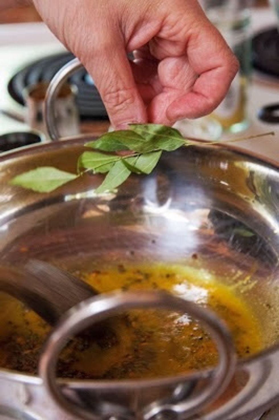 Stir everything well and toss in the curry leaves.