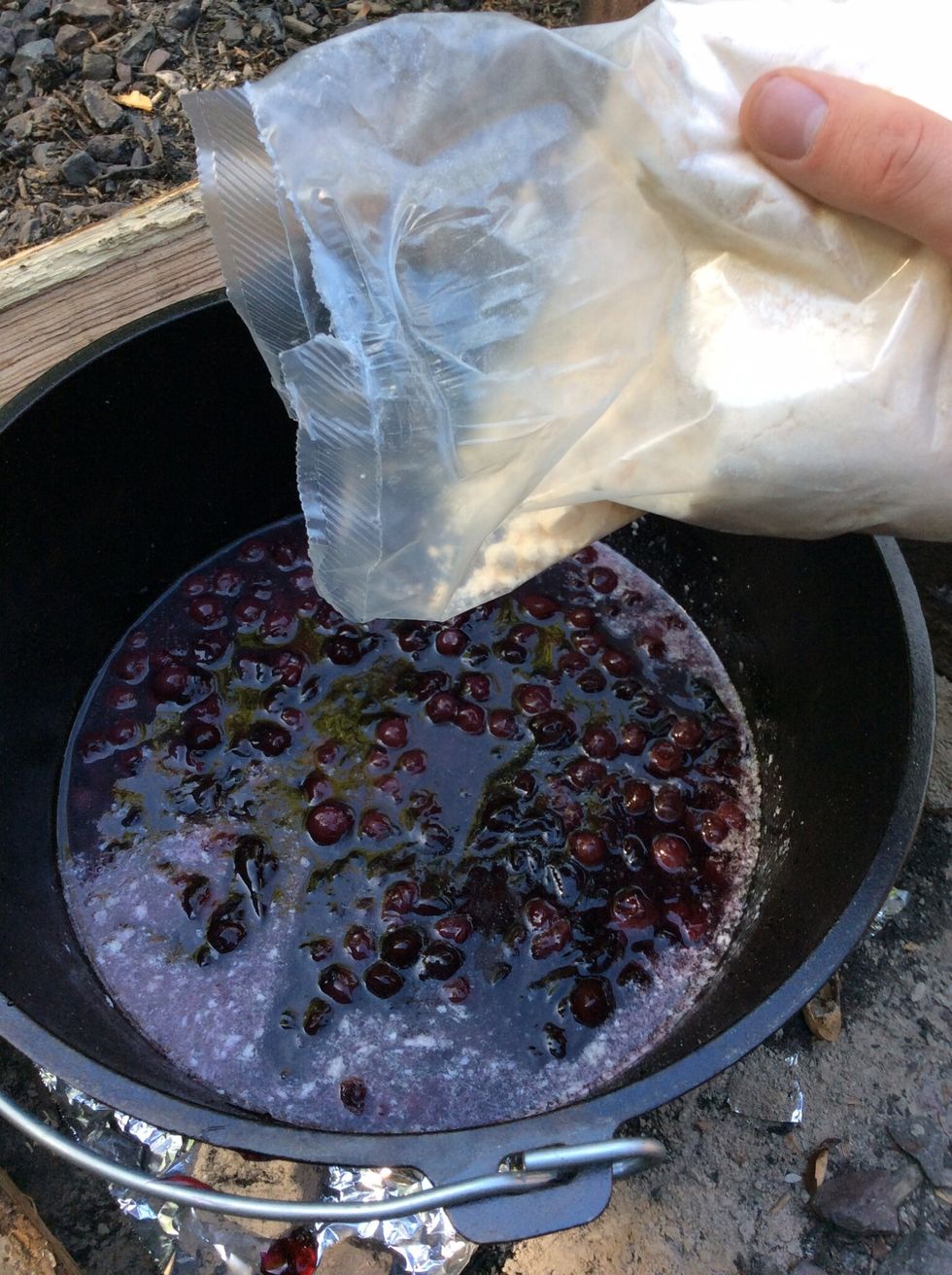 Stir fruit together lightly. Get the cake mix and sprinkle over the the top of the fruit fillings.