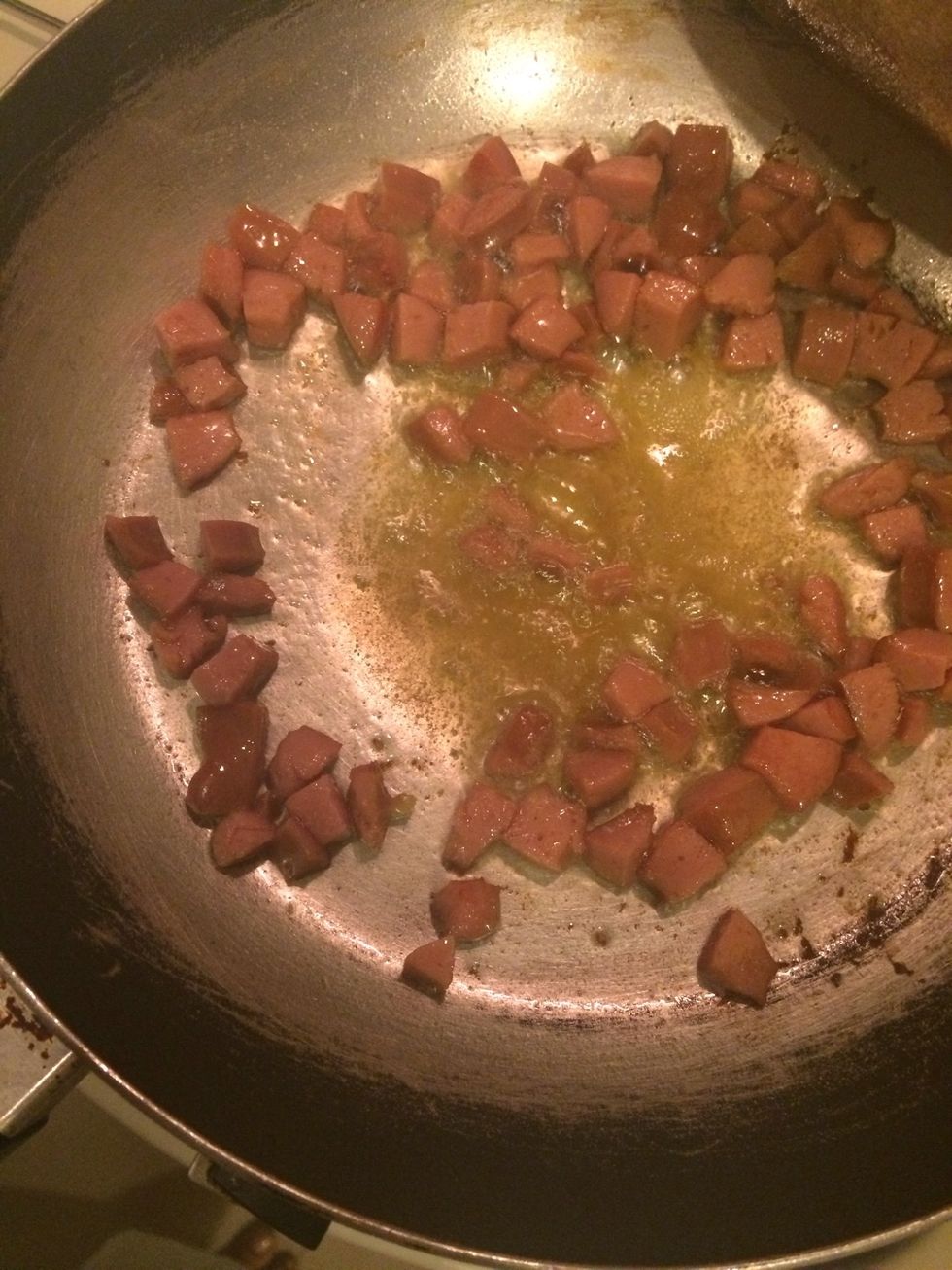 Stir fry diced beef frankfuter sausages in the hot butter, then put the garlic and onion , wait till golden brown