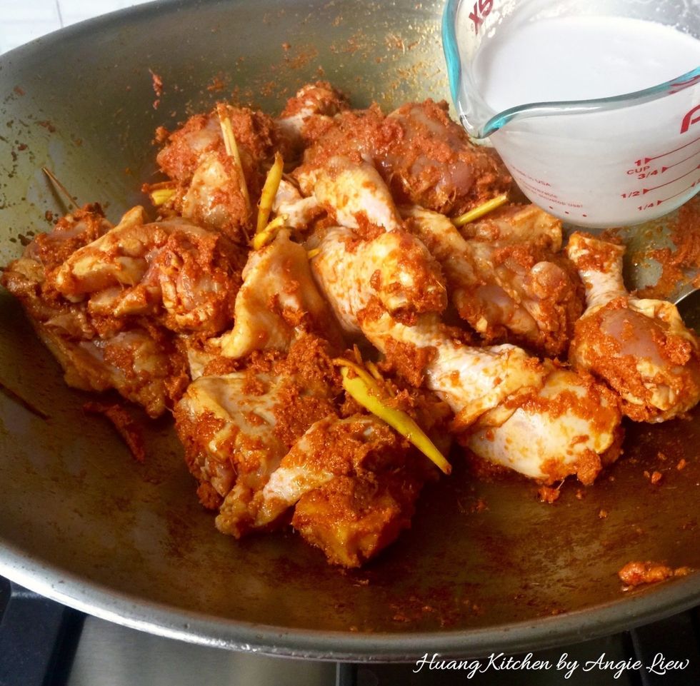 Stir fry the chicken with the aromatic spice paste until the skin begins to brown slightly and all the chicken has been well coated with the spice. Then add thick coconut milk.