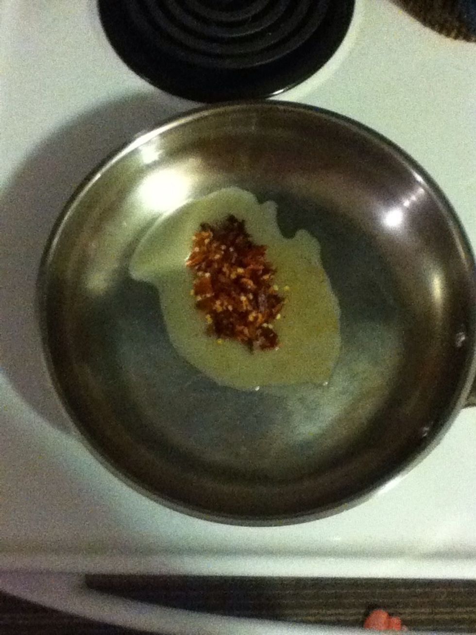 Stir fry those chile flakes for a minute until they bubble, then add the chicken.