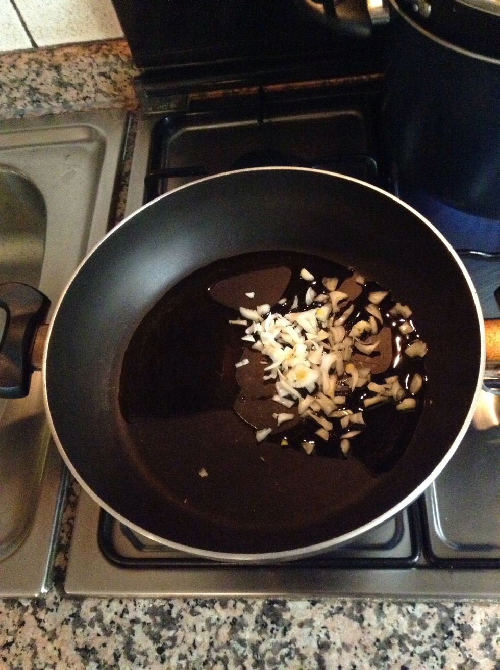 Stir frying the onion in a pan with olive oil.
