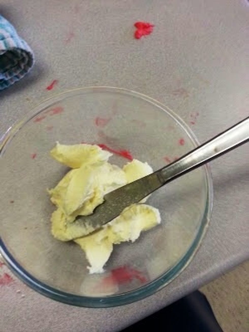Stir icing and red food dye in a bowl