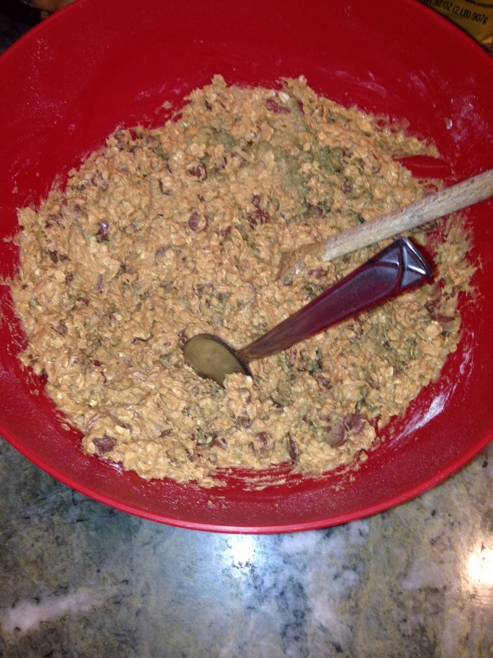 Stir in 2 cups of oats, 1 1/2 cups of flour, 1 teaspoon of baking soda, 1/4 teaspoon of salt, and 1 cup of chocolate chips
