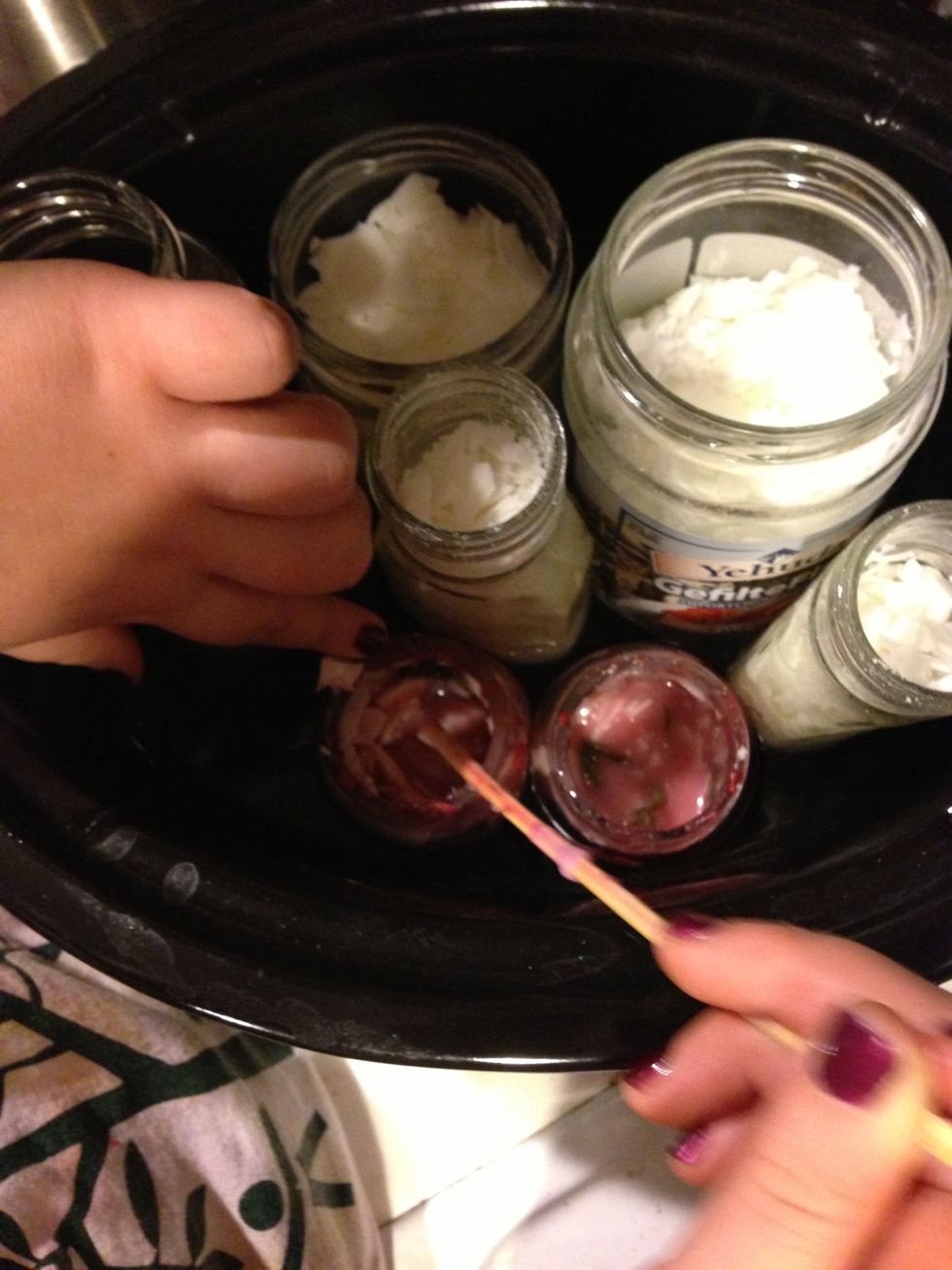 Stir in oil essence and new wax chips as wax melts. Leave for another 2 hours.