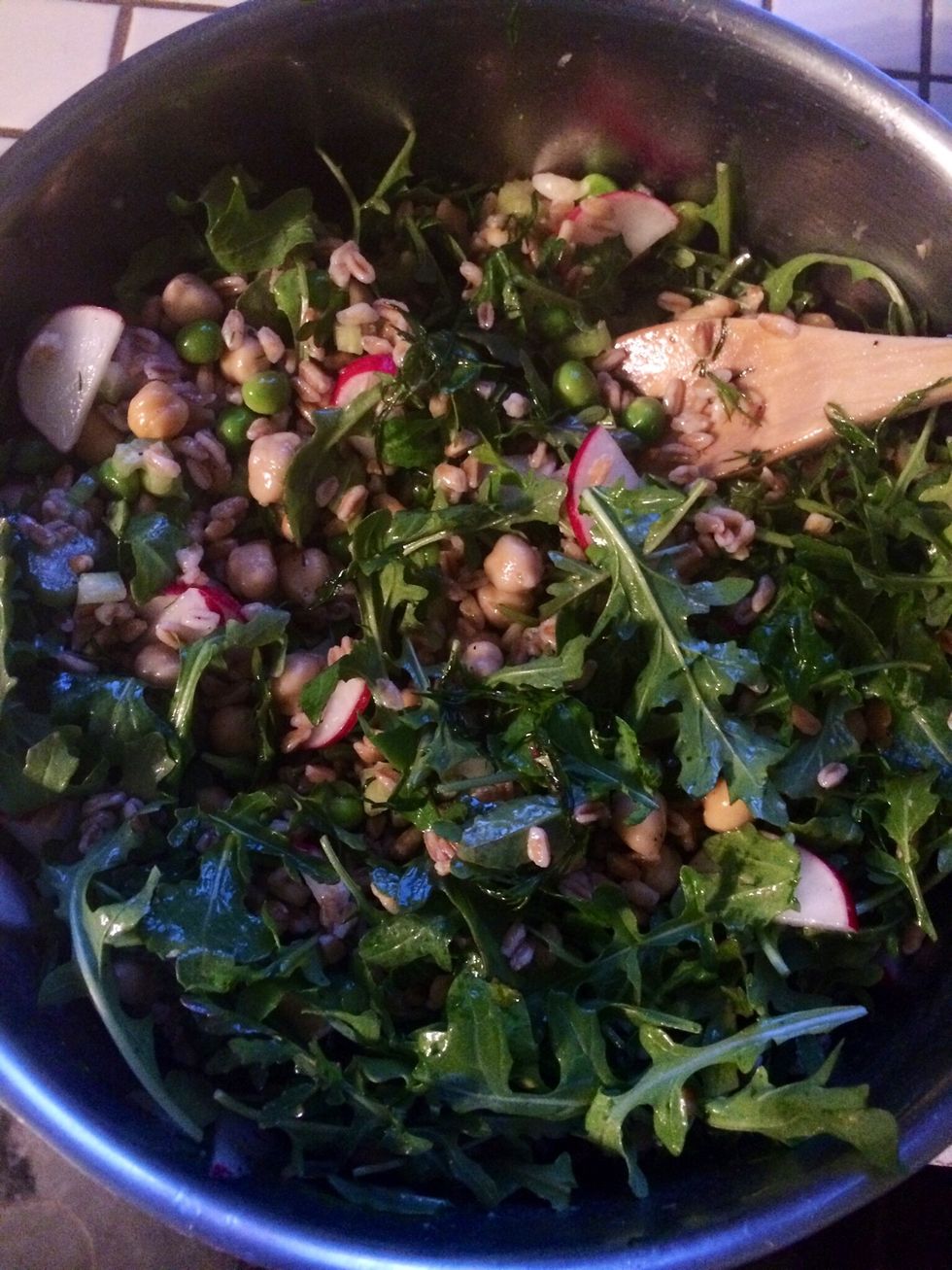 Stir in the arugula until thoroughly coated. Cut the second lemon and squeeze into the salad to taste.