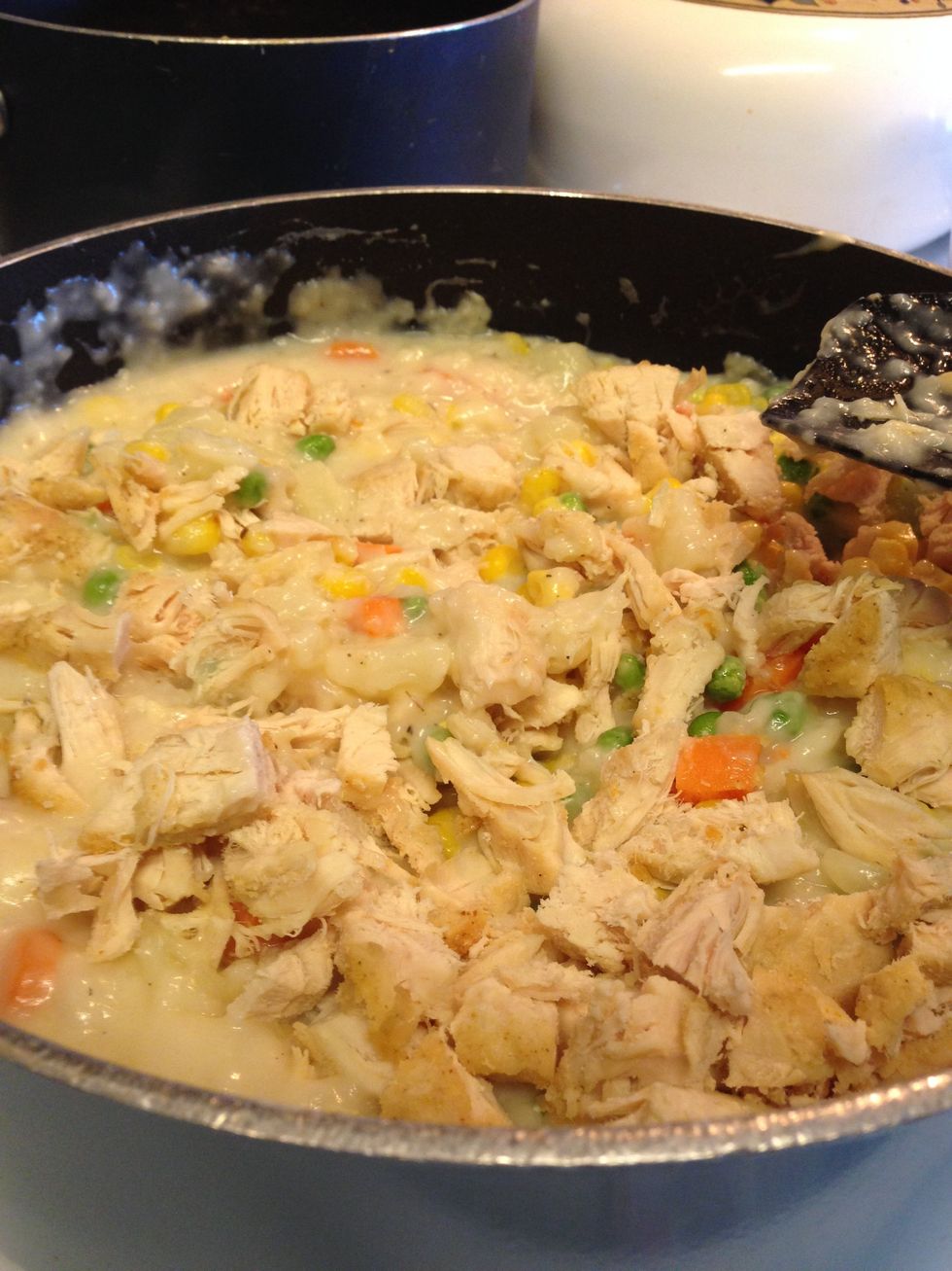 Stir in the chicken, peas, corn, and potatoes/carrots. Remove from heat. Cook for about 5 minutes.