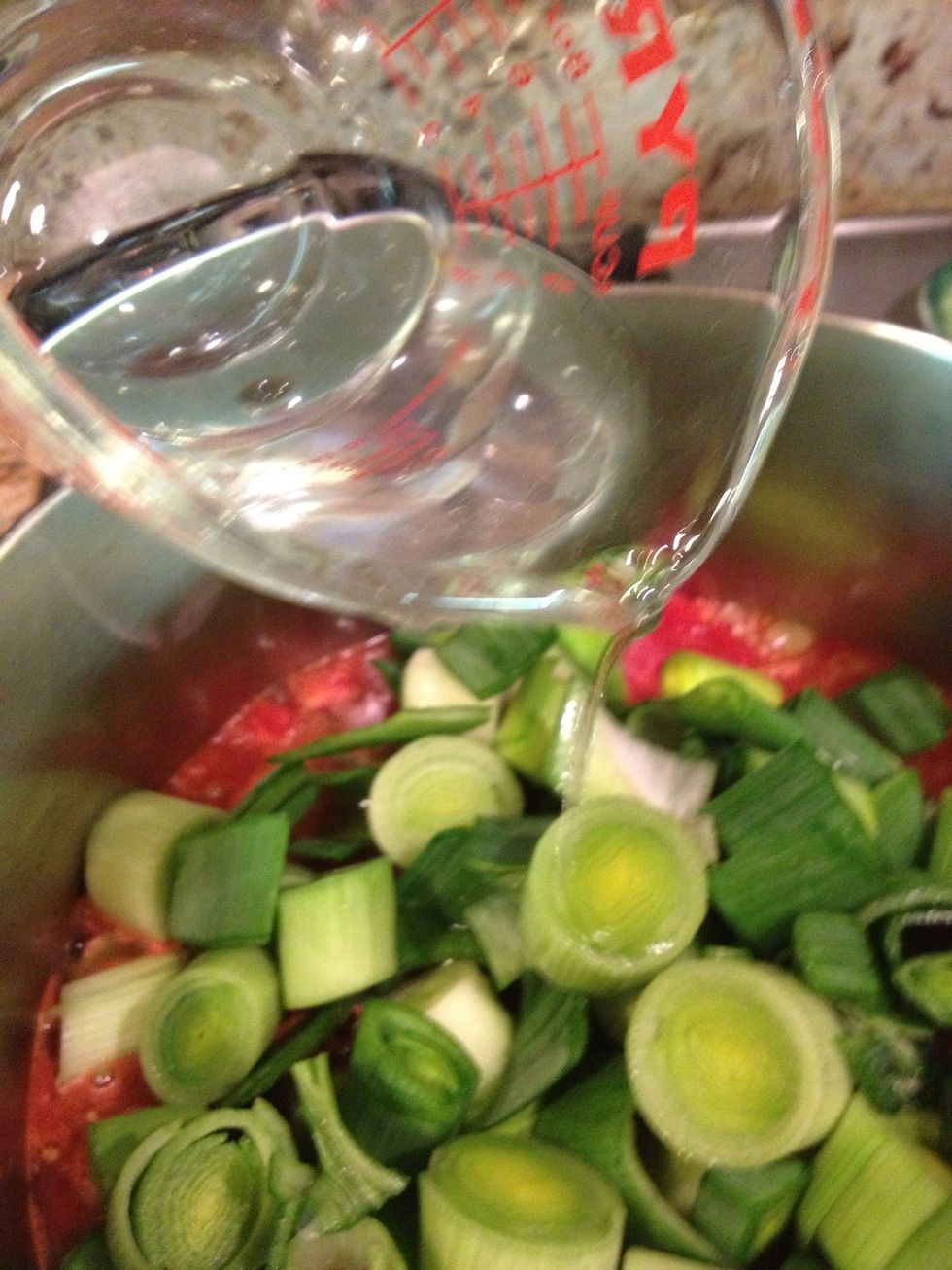 Stir in the reserved tomato juice. If you don't have enough, add water to the measuring cup until you have 11/2 cups. Cover and cook for about 1 hour until the leeks are soft and flavors have blended.