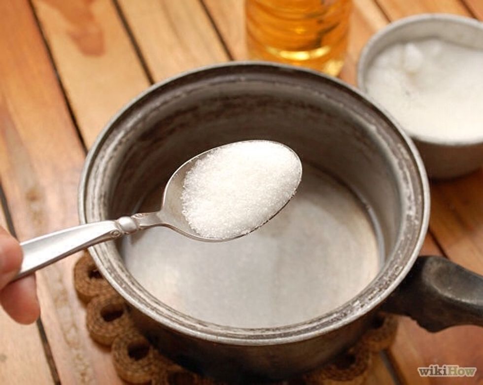 Stir in the sugar 1/2 cup at a time continue adding it until it starts collecting at the bttom of the pot n will not dissolve even when u stir. Ths will tke a while n a good bit of sugar but not a lot