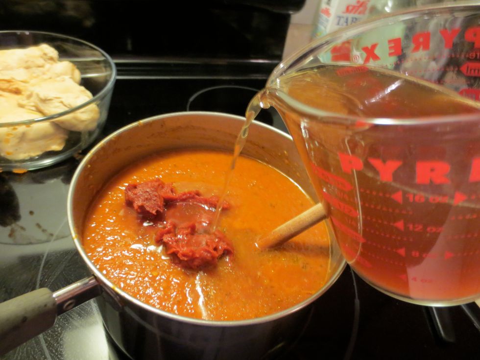 Stir in tomato paste and a 1/4 cup of the reserved chicken stock. Cook for about 10 minutes. Check seasoning, more salt, pepper, chile powder? Too much spice/heat? add more reserved chicken stock.