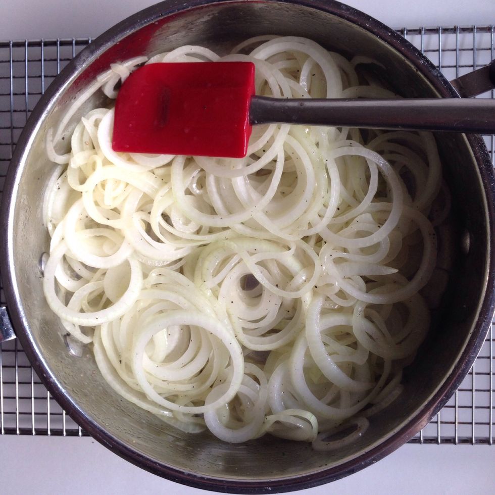 Stir onions to break them up and coat them with butter.